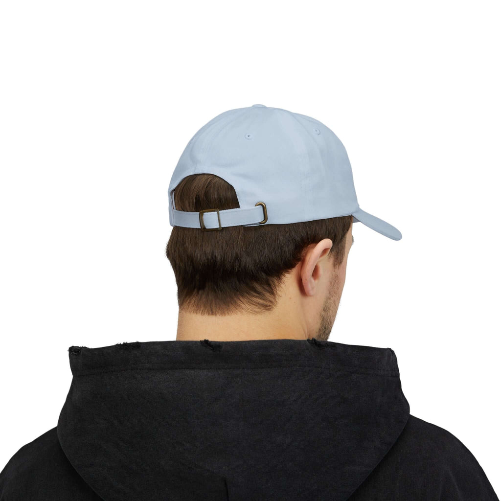 Side view of man wearing beige TeamSharkcage classic cap, showcasing embroidered logo and curved brim design for everyday casual style.