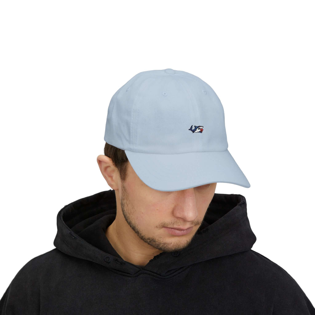 Back view of man wearing beige classic cap featuring adjustable metal strap and stitched TeamSharkcage branding, ideal for casual summer fashion.