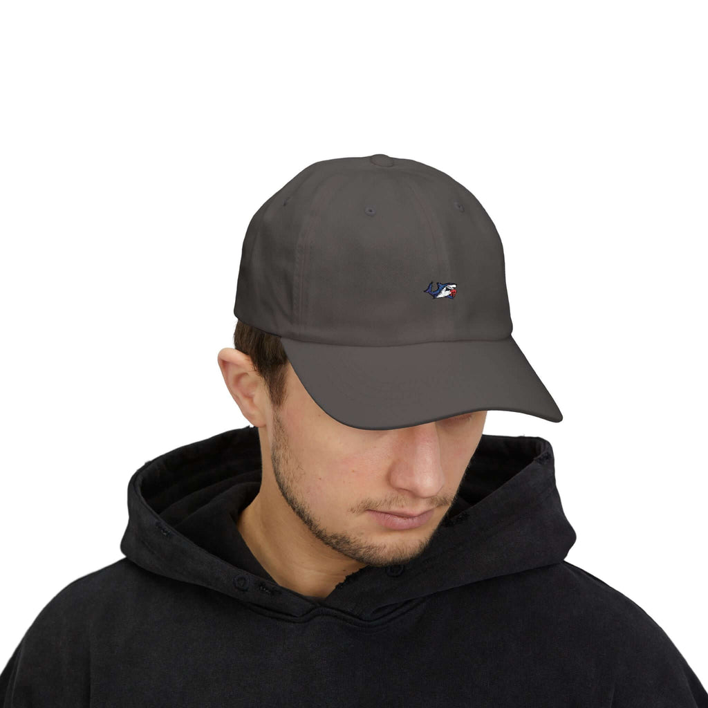 Man wearing a navy blue TeamSharkcage Classic Cap with white embroidered logo, ideal for athletic and casual outfits.