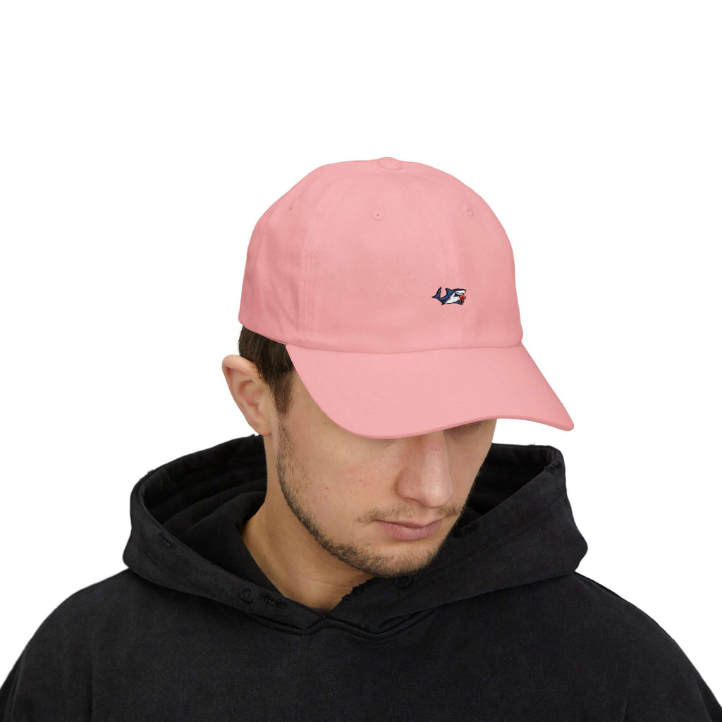 Man wearing a black TeamSharkcage Classic Cap featuring a bold red and white embroidered logo, perfect for streetwear and casual looks.