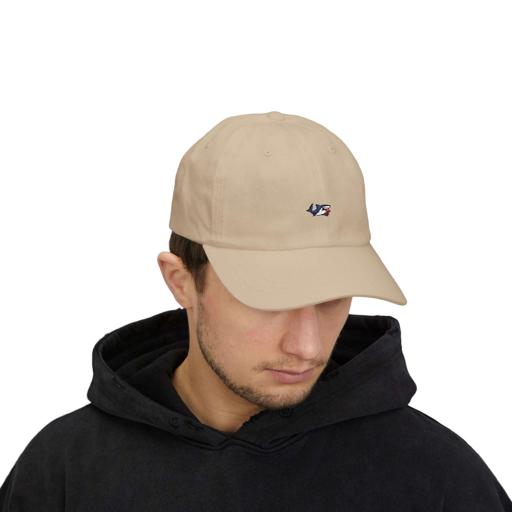 Man wearing a beige classic cap with TeamSharkcage logo, perfect for casual summer wear and everyday style.